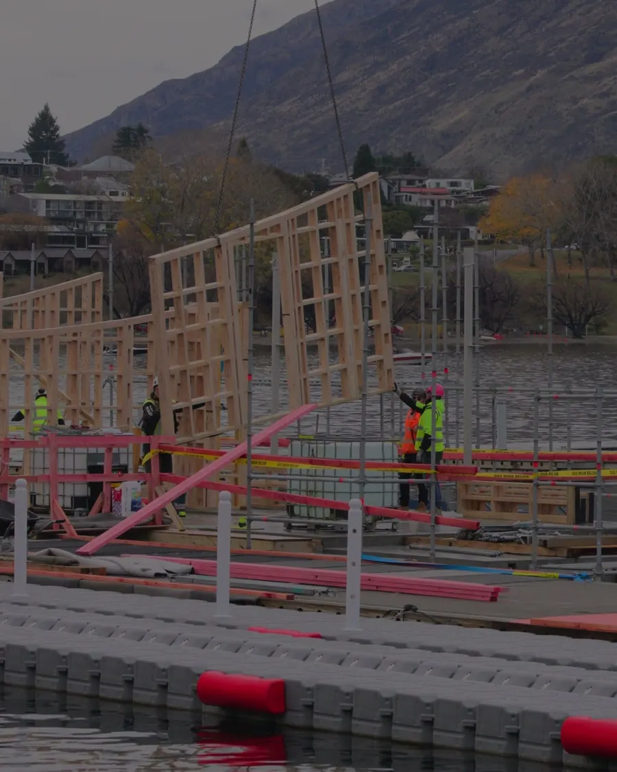 The Aluume floating sauna frame being built at Frankton Marina with the mountains behind
