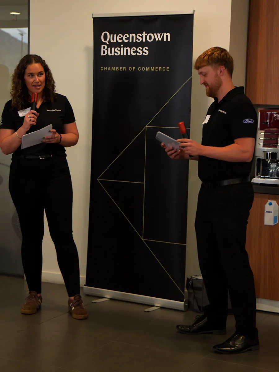 Ella Gorton and Alfie Camponi of Macaulay Motors hosting the speeches beside a Queenstown Business banner