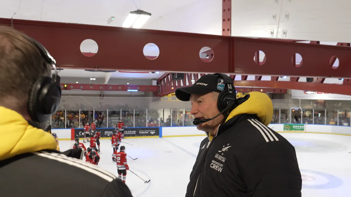 A member of the broadcast crew in a headset rinkside at the Queenstown Ice Arena during the semi-final weekend