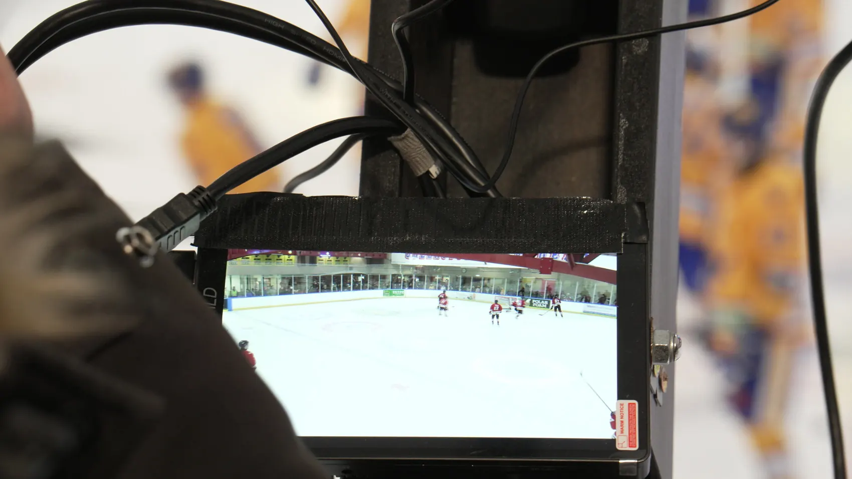A camera monitor showing the live feed of a Wakatipu Wild ice hockey game at the Queenstown Ice Arena