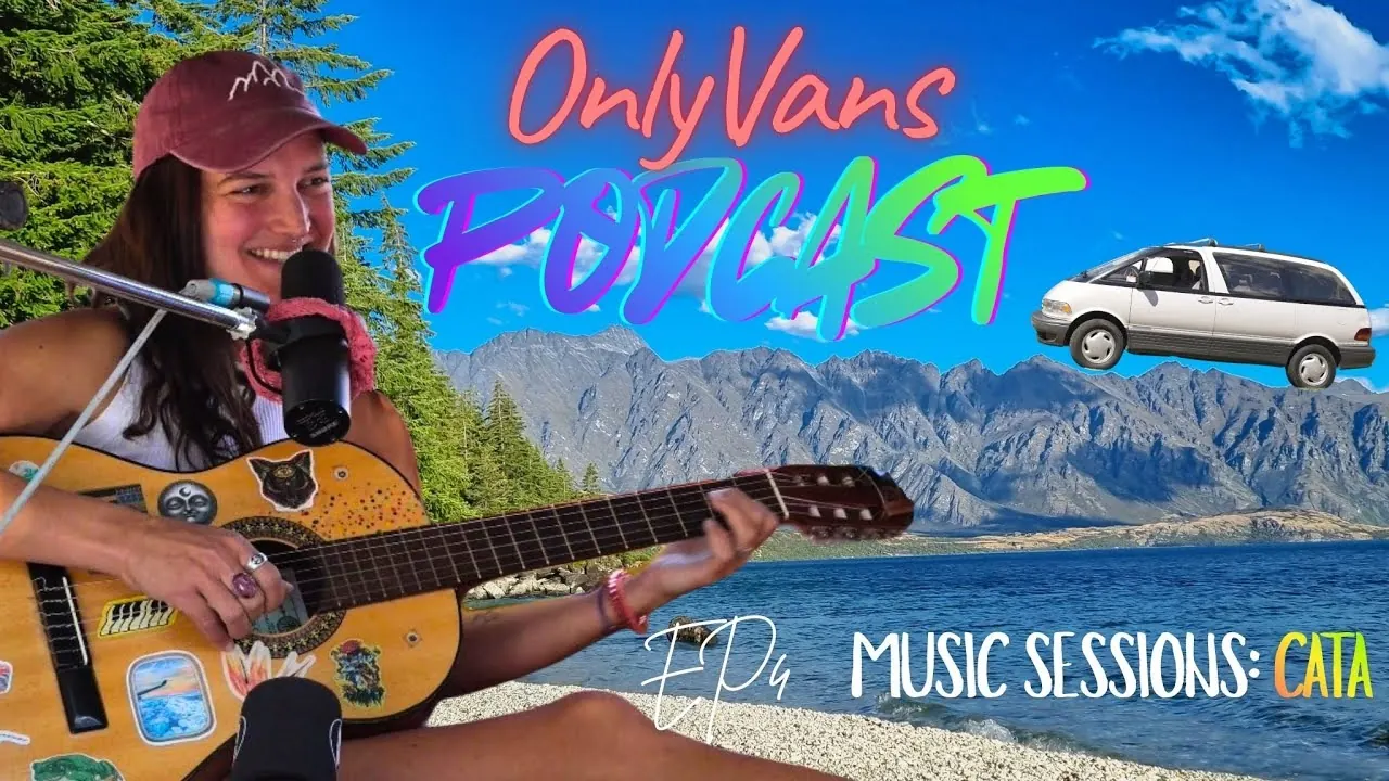 A musician with guitar and microphone by Lake Wakatipu, from an OnlyVans Music Session